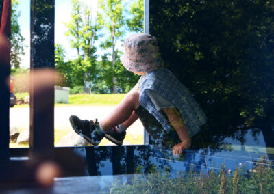 A young boy looking out of a window