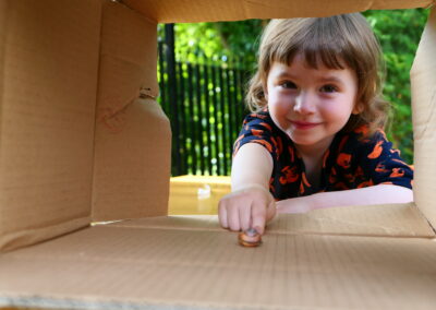 A young girl pointing at a snail